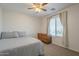 Comfortable bedroom with a window, dresser, and ceiling fan for added convenience at 3247 N Loma Vis, Mesa, AZ 85213
