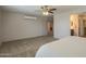 Carpeted bedroom featuring a modern ceiling fan and doorway to a secondary room at 3247 N Loma Vis, Mesa, AZ 85213