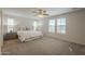 Spacious bedroom with natural light from two windows, neutral carpet and two bedside tables at 3247 N Loma Vis, Mesa, AZ 85213