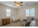 Bedroom featuring a crib, dresser, ceiling fan, and a reading chair at 3247 N Loma Vis, Mesa, AZ 85213
