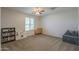 Bonus room featuring neutral walls and carpet, bookcase, play kitchen and window views at 3247 N Loma Vis, Mesa, AZ 85213