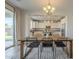 Dining room showcases a wood table and chairs adjacent to a sliding glass door and open to a modern kitchen at 3247 N Loma Vis, Mesa, AZ 85213