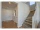 Spacious entryway featuring wood floors, a carpeted staircase, and views into other rooms at 3247 N Loma Vis, Mesa, AZ 85213