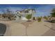 Two-story home with a two-car garage, neutral color, stone accents, and low-maintenance landscaping at 3247 N Loma Vis, Mesa, AZ 85213
