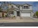 Inviting two-story home showcasing a two-car garage and a charming entryway with a dark-colored door at 3247 N Loma Vis, Mesa, AZ 85213