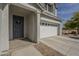 Charming home featuring a two-car garage and inviting entryway with a dark front door at 3247 N Loma Vis, Mesa, AZ 85213