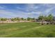 Inviting community green space featuring desert landscaping and mature trees, providing a welcoming gathering place at 3247 N Loma Vis, Mesa, AZ 85213