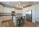 Beautiful kitchen with white cabinetry, stainless steel appliances, and a center island with seating at 3247 N Loma Vis, Mesa, AZ 85213