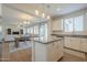Open concept kitchen with granite countertops, pendant lighting, and a view into the living and dining areas at 3247 N Loma Vis, Mesa, AZ 85213