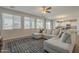 Bright living room with a large sectional couch, wood flooring, and multiple windows at 3247 N Loma Vis, Mesa, AZ 85213