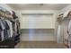 Spacious walk-in closet with ample shelving and storage space for clothing and accessories at 3247 N Loma Vis, Mesa, AZ 85213
