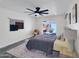 Spacious bedroom with a modern ceiling fan, sitting area, and a large window at 3401 N 37 St # 14, Phoenix, AZ 85018
