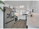 This bright kitchen has stainless steel appliances, white cabinets and quartz countertops at 3401 N 37 St # 14, Phoenix, AZ 85018