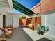 Cozy outdoor patio features bench seating, a dining table, and a retractable awning for shade at 3401 N 37 St # 14, Phoenix, AZ 85018