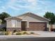 Charming single-story home featuring a stone facade, a well-manicured yard, and a two-car garage at 3499 E Audrey Dr, San Tan Valley, AZ 85143