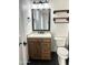 Bathroom with wood vanity, drawers, a sink, dark floors, and a dark framed mirror at 3514 W Altadena Ave, Phoenix, AZ 85029