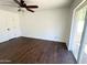 Bedroom featuring dark wood floors, a ceiling fan, a door, and sliding glass doors at 3514 W Altadena Ave, Phoenix, AZ 85029