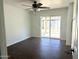 Bedroom featuring dark wood floors, a ceiling fan, and sliding glass doors that lead to a patio at 3514 W Altadena Ave, Phoenix, AZ 85029