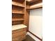 Walk-in closet featuring wood shelving, drawers, a marble countertop, and white walls at 3514 W Altadena Ave, Phoenix, AZ 85029