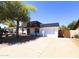 Single-story home with a long driveway, an RV gate, desert landscaping, and an attached garage at 3514 W Altadena Ave, Phoenix, AZ 85029