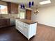 Kitchen island featuring custom cabinets, a butcher block top, and pendant lighting at 3514 W Altadena Ave, Phoenix, AZ 85029