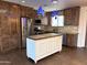 Renovated kitchen boasts custom wood cabinets, stainless steel appliances, and a white kitchen island at 3514 W Altadena Ave, Phoenix, AZ 85029