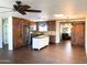 Open-concept kitchen featuring custom wood cabinets, stainless steel appliances, and a central island at 3514 W Altadena Ave, Phoenix, AZ 85029