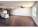 Open living area with wood floors, a ceiling fan, and views into the kitchen and dining areas at 3514 W Altadena Ave, Phoenix, AZ 85029