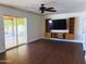 Open-concept living room with backyard patio access and custom built-in cabinets at 3514 W Altadena Ave, Phoenix, AZ 85029