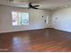 Spacious living room featuring wood-look tile floors, ample natural light, and neutral decor at 3514 W Altadena Ave, Phoenix, AZ 85029