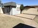 A white shed offers additional storage in the backyard with a charming design and a small patio area at 3514 W Altadena Ave, Phoenix, AZ 85029