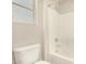 Bright bathroom featuring a white toilet and tiled tub-shower combo at 3552 E Carla Vista Dr, Gilbert, AZ 85295