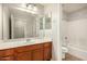 Bathroom featuring a vanity, sink, and a shower-tub combination, providing a clean and well-maintained space at 3552 E Carla Vista Dr, Gilbert, AZ 85295