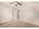 Bright bedroom featuring neutral walls, carpet floors, with double doors and a ceiling fan at 3552 E Carla Vista Dr, Gilbert, AZ 85295