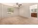 Bright bedroom featuring neutral walls, carpet floors, and a ceiling fan, offering a calm and comfortable space at 3552 E Carla Vista Dr, Gilbert, AZ 85295