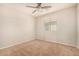 Bright bedroom featuring neutral walls, carpet floors, and a ceiling fan, offering a calm and comfortable space at 3552 E Carla Vista Dr, Gilbert, AZ 85295