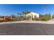 Charming community clubhouse with palm trees, offering gathering spaces and amenities for residents at 3552 E Carla Vista Dr, Gilbert, AZ 85295