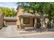 Beautiful home with covered porch, attached garage, and desert landscaping for great curb appeal at 3552 E Carla Vista Dr, Gilbert, AZ 85295