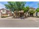 Inviting two-story home with a covered porch, well-kept landscaping, and mature trees at 3552 E Carla Vista Dr, Gilbert, AZ 85295