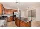 Kitchen island with dark granite countertop and stainless steel refrigerator at 3552 E Carla Vista Dr, Gilbert, AZ 85295