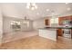 Open-concept living room and kitchen boasts lots of natural light and sliding glass door to back yard at 3552 E Carla Vista Dr, Gilbert, AZ 85295