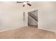 Large living room with neutral carpet, ceiling fan, and view of the staircase and entryway at 3552 E Carla Vista Dr, Gilbert, AZ 85295