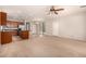 Open floor plan of kitchen and living room with fan and access to the backyard at 3552 E Carla Vista Dr, Gilbert, AZ 85295
