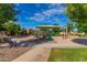 Community playground with colorful play structures, swings, and a shaded seating area offers a fun and safe environment for  at 3552 E Carla Vista Dr, Gilbert, AZ 85295