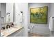 Powder bathroom features a decorative vanity and large abstract painting at 37200 N Cave Creek Rd # 1122, Scottsdale, AZ 85262