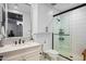 Clean bathroom featuring white cabinets, quartz countertop, and walk-in shower with black trim at 37200 N Cave Creek Rd # 1122, Scottsdale, AZ 85262
