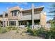 Contemporary home featuring a multi-level deck, desert landscaping, and a seamless indoor-outdoor living space at 37200 N Cave Creek Rd # 1122, Scottsdale, AZ 85262