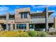 Exterior of a multi-story home with stone accents, modern design, and outdoor living spaces at 37200 N Cave Creek Rd # 1122, Scottsdale, AZ 85262