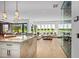 Bright open concept kitchen with an island and adjacent living room with views to the golf course at 37200 N Cave Creek Rd # 1122, Scottsdale, AZ 85262