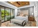 Serene bedroom featuring a wood ceiling, ensuite access to a covered patio and landscaped yard at 37200 N Cave Creek Rd # 1122, Scottsdale, AZ 85262